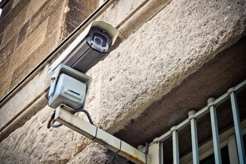 Surveillance camera mounted on the exterior of a building.