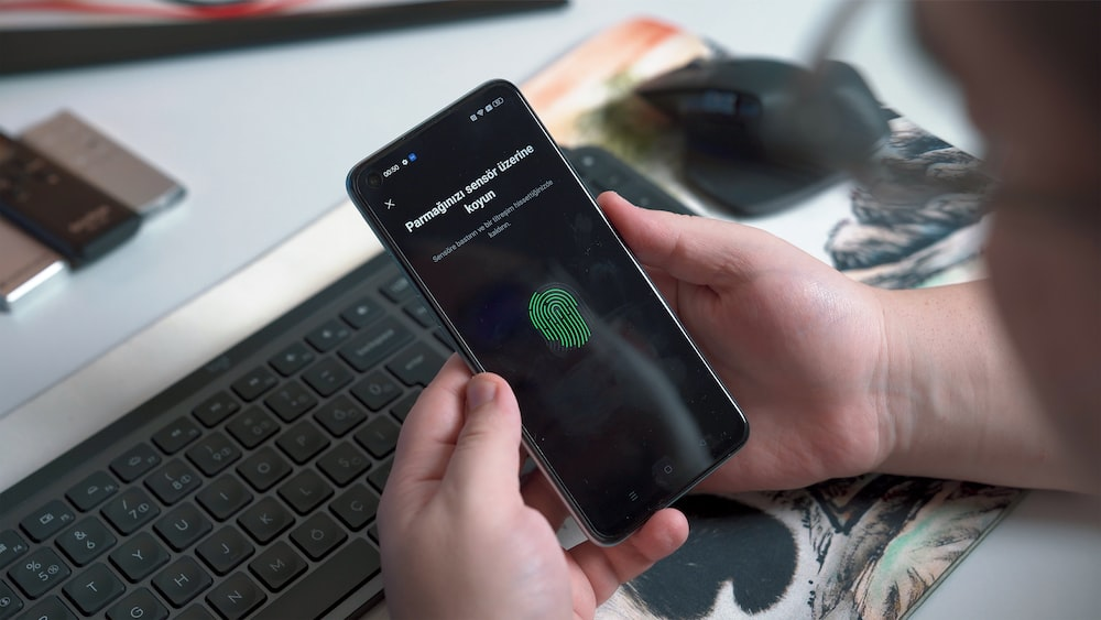 Person authenticating fingerprint on a smartphone security app.