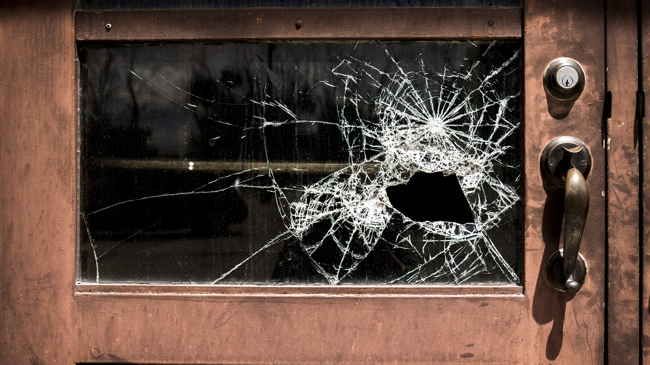 A Wooden School Door’s Glass Panel Shattered by a Bullet