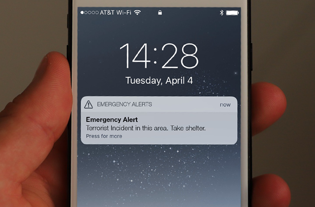 A Phone Display Featuring an Emergency Alert About a Terrorist Incident from a Mass Notification System